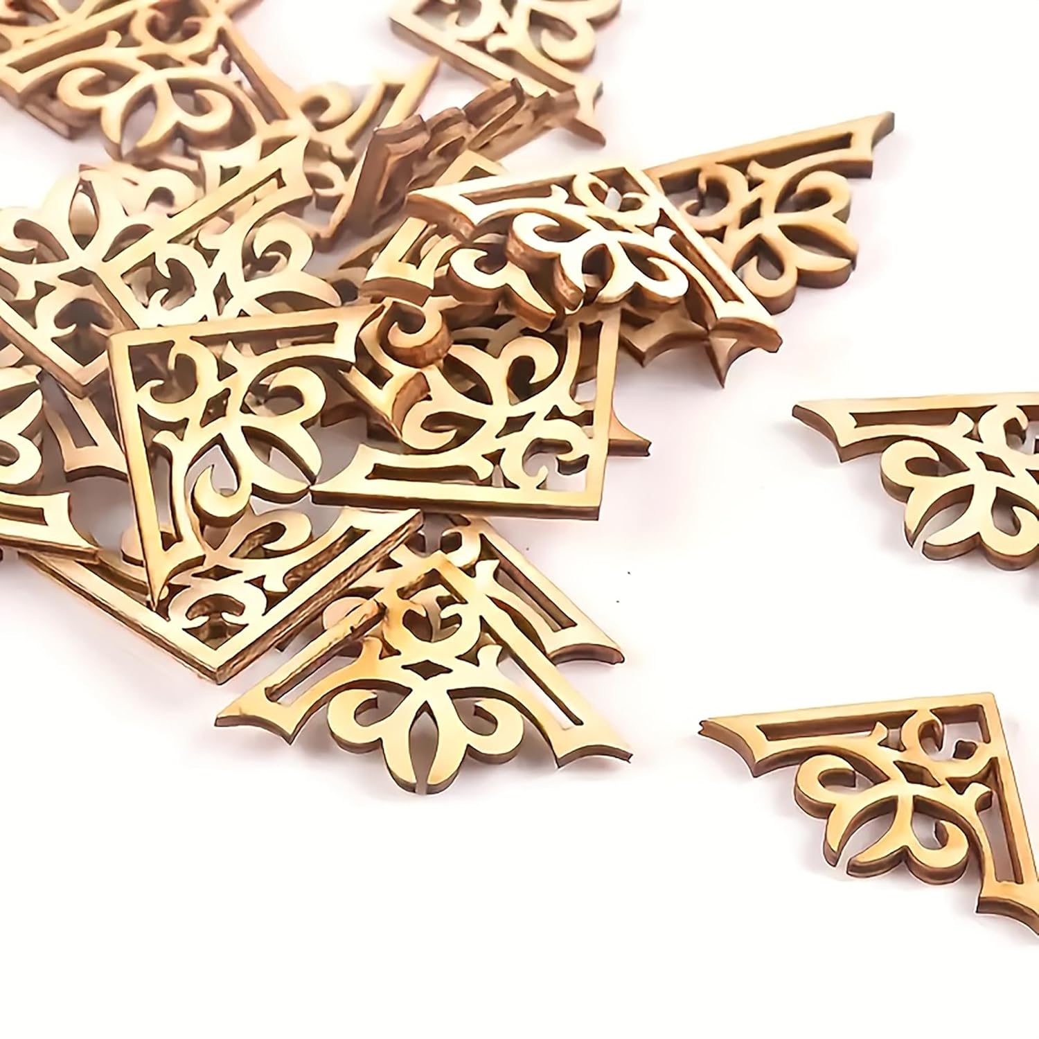 Gold decorative corner pieces with intricate patterns on a white background
