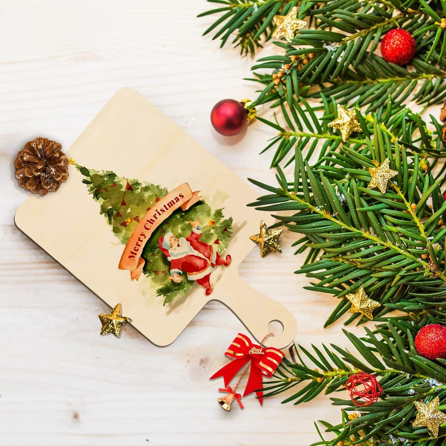 Christmas-themed cutting board with Santa Claus design, surrounded by festive decorations on a light wooden surface.