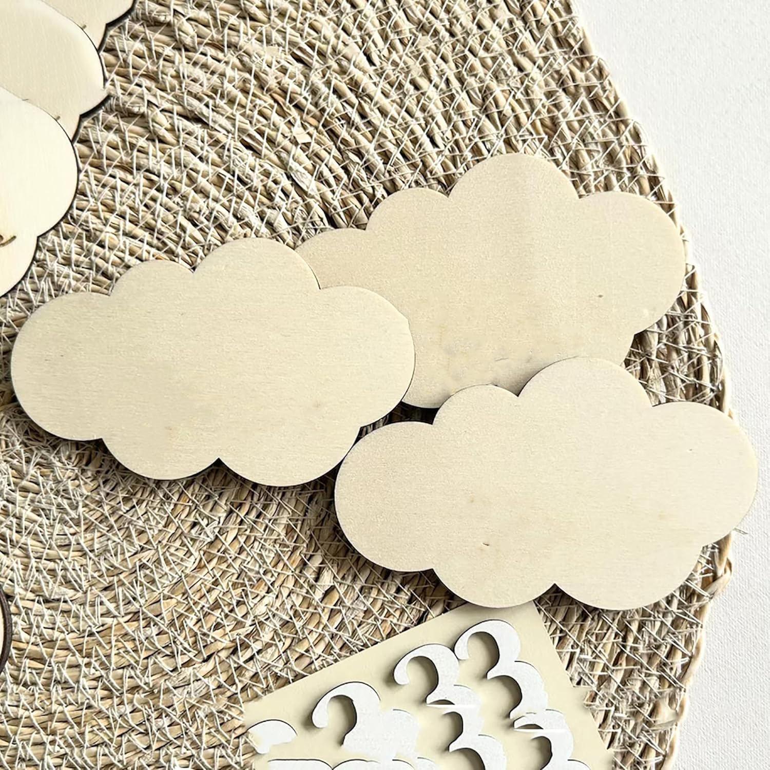 Wooden cloud shapes on a textured surface