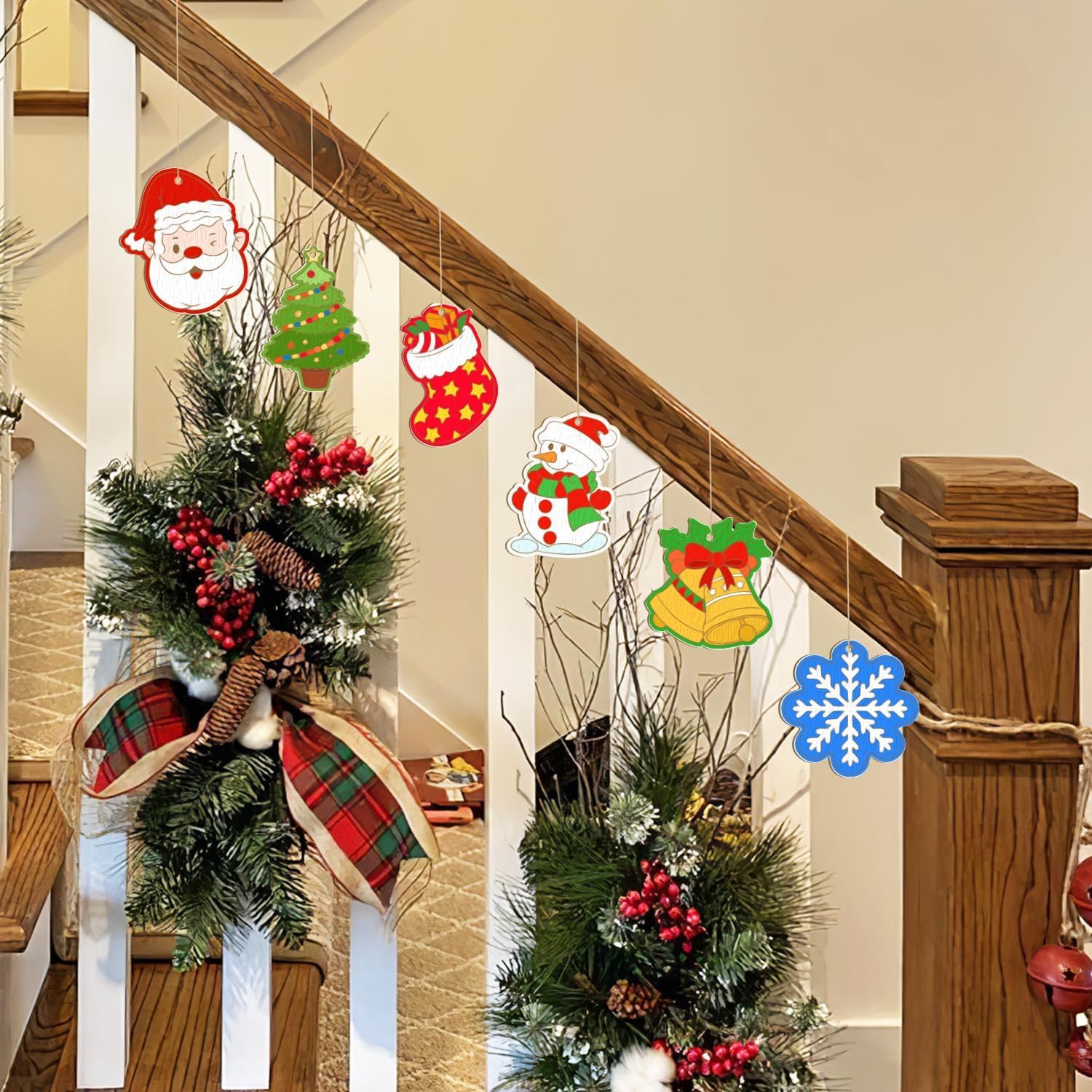 Decorative Christmas ornaments on a staircase with wreaths and festive elements.