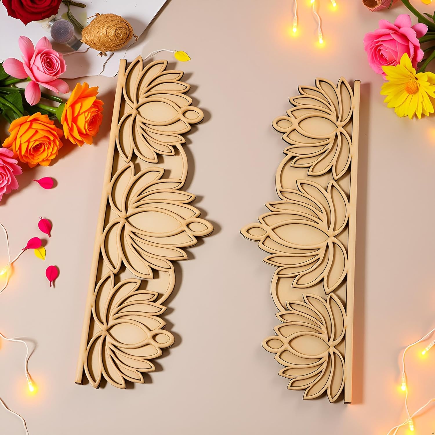Two wooden floral patterns on a light surface with flowers and string lights around.