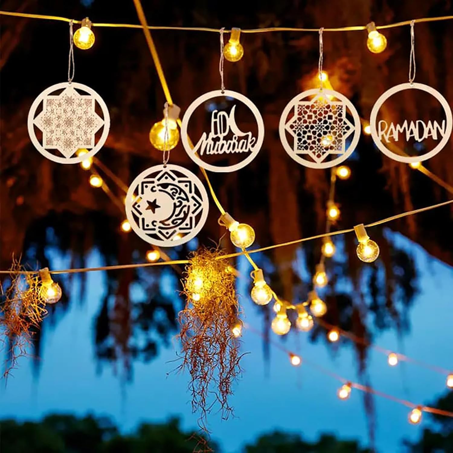 Decorative lights with 'Mubarak' and 'Ramadan' text hanging against a night sky.