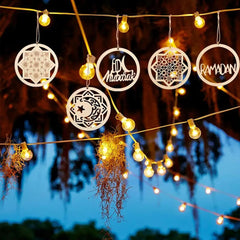 Decorative lights with 'Mubarak' and 'Ramadan' text hanging against a night sky.