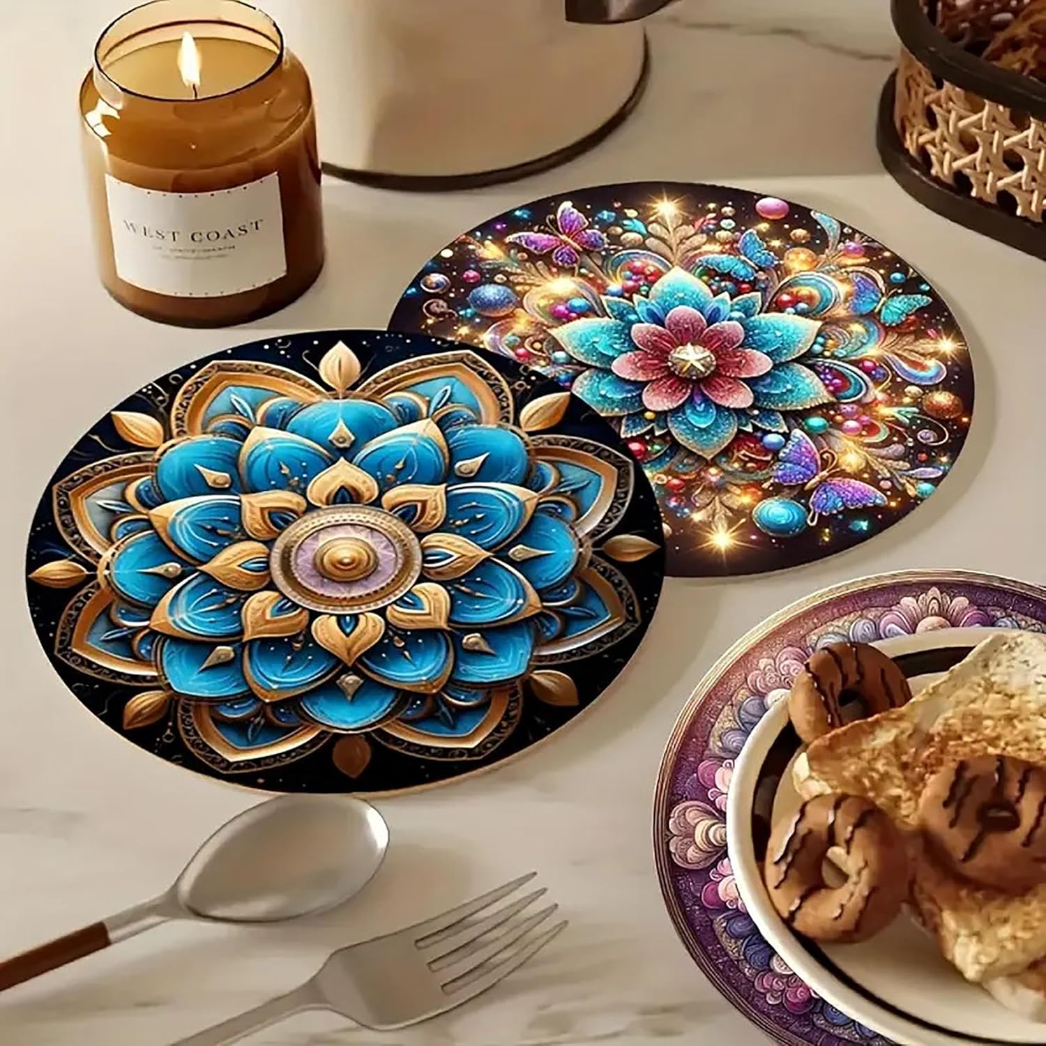 Decorative placemats with intricate designs on a table setting with a candle and food.