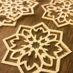 Wooden snowflake cutouts on a wooden surface
