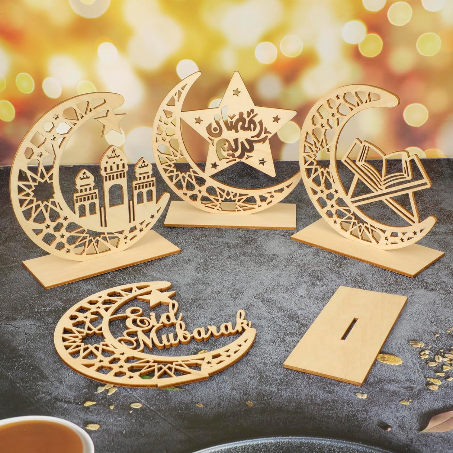Decorative wooden cutouts of crescent moons and stars with 'Edad Mubarak' text on a blurred background.