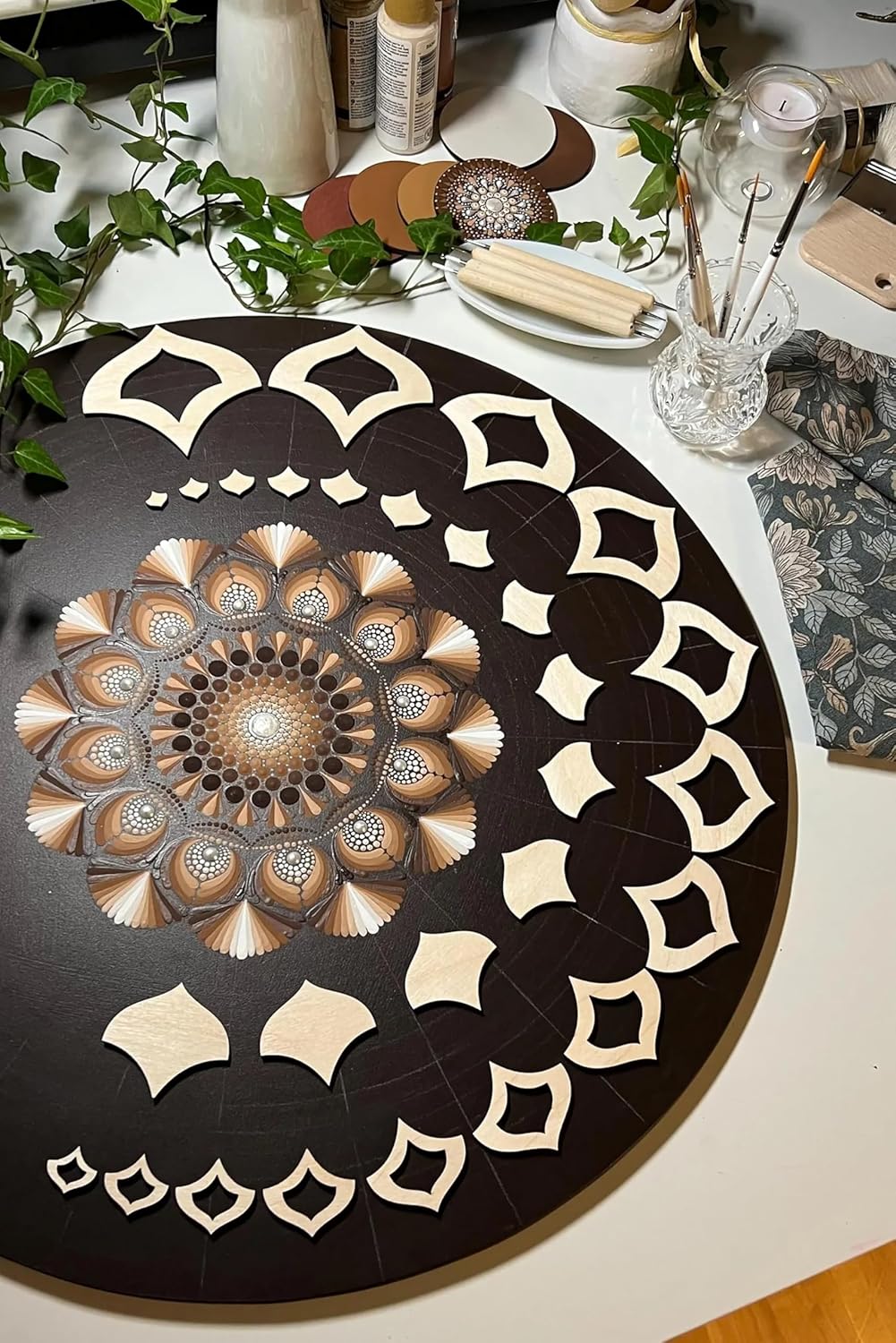 Decorative mandala on a table with art supplies