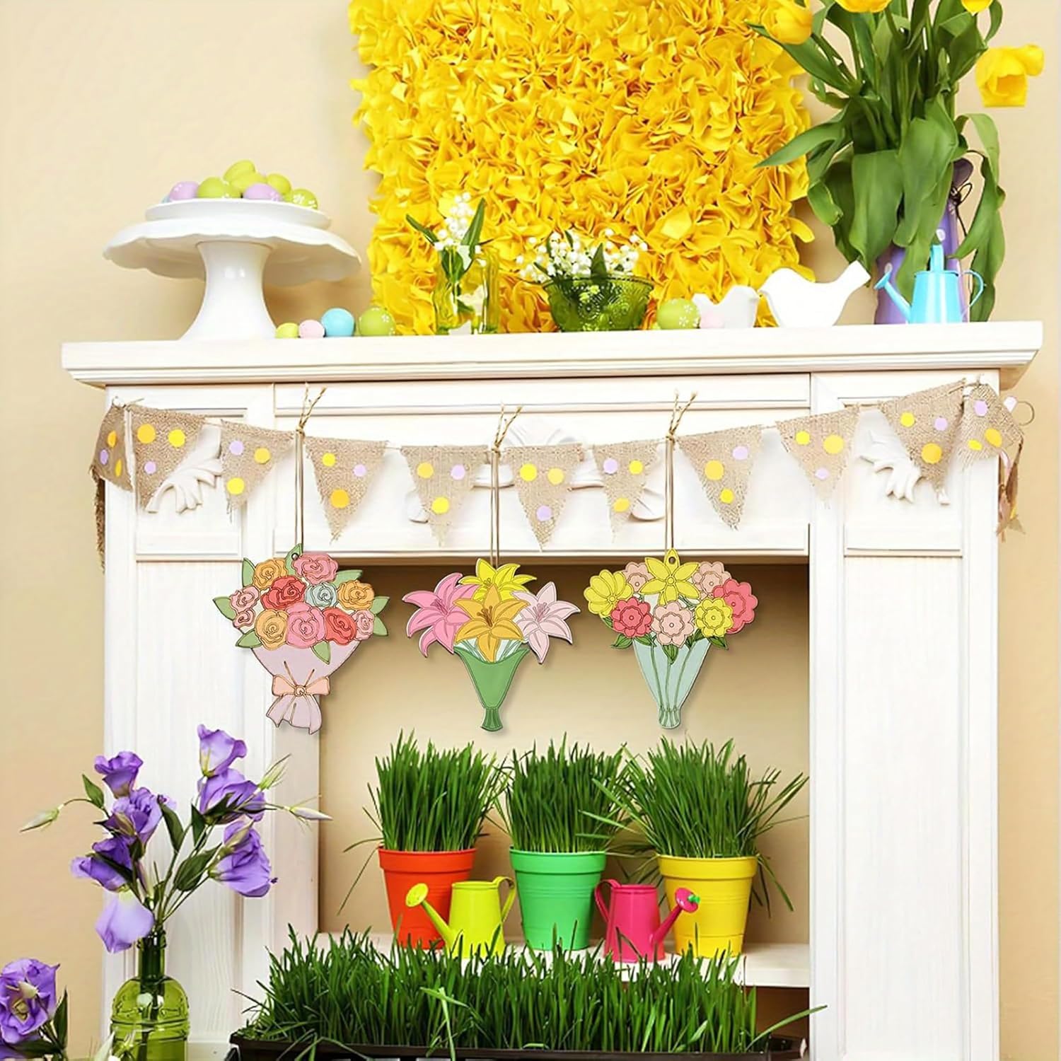 Decorative mantel with spring-themed decorations including flowers, grass, and a banner.