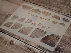 Stencil with geometric shapes on a wooden surface