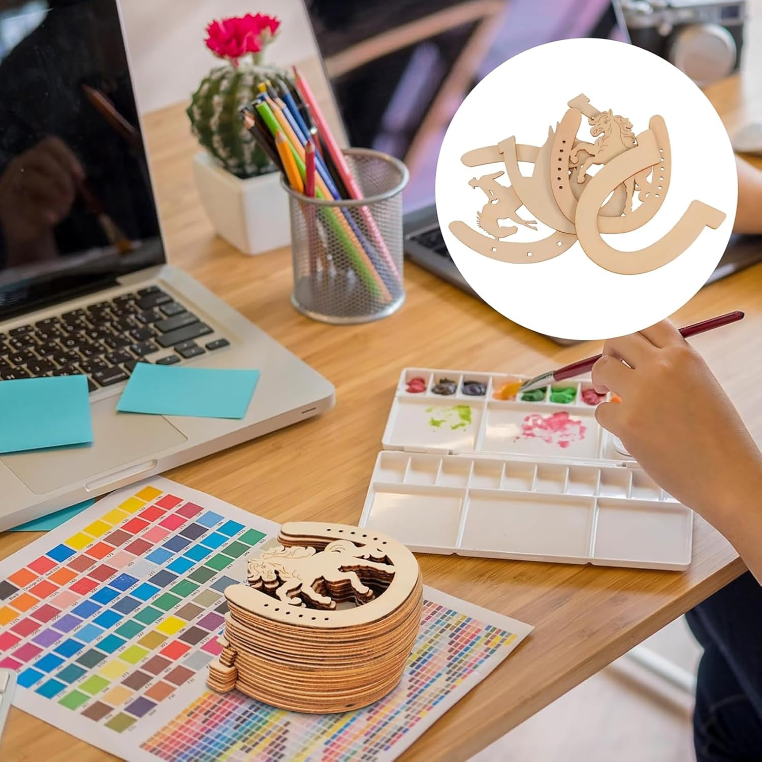 Wooden geometric shapes on a desk with art supplies and a laptop.