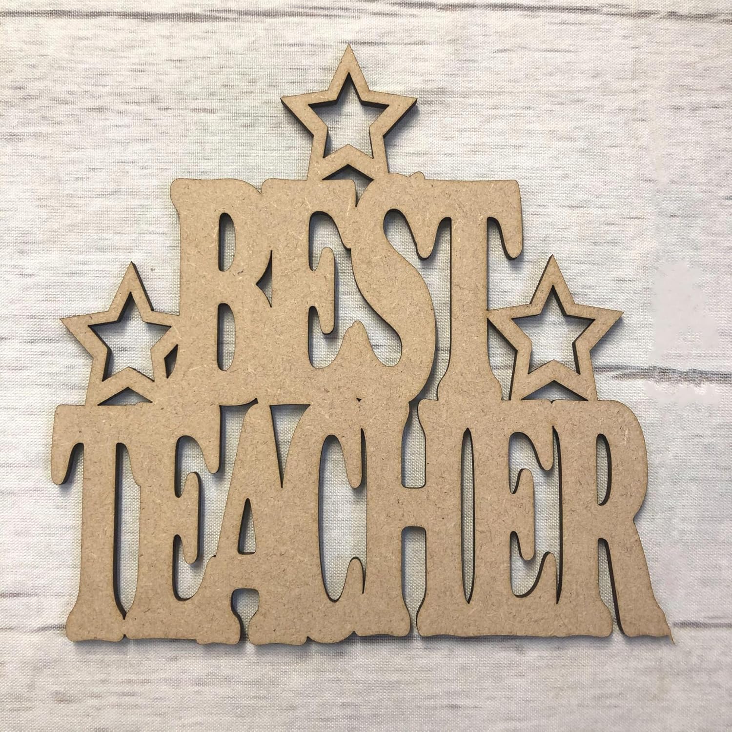 Wooden decorative sign with 'BEST TEACHER' text and stars on a light wooden background