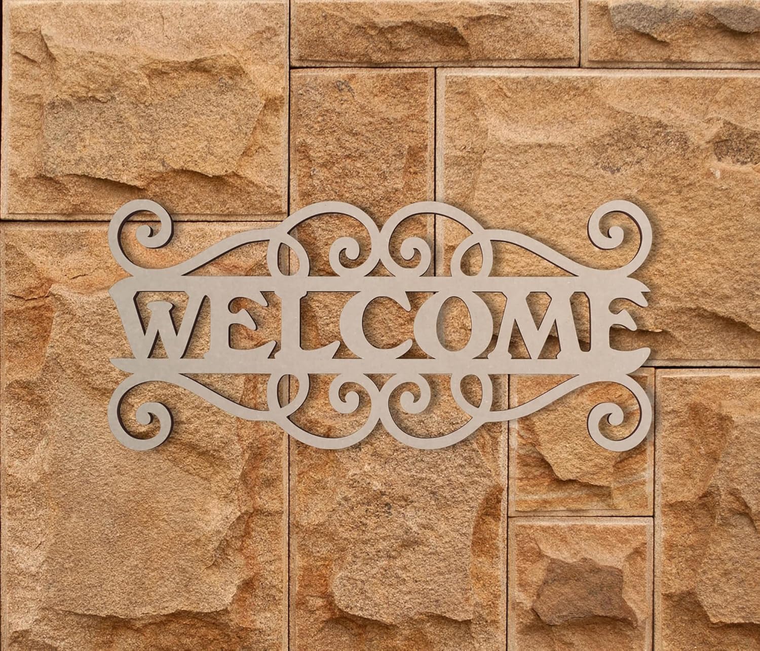Decorative metal 'WELCOME' sign on a stone wall