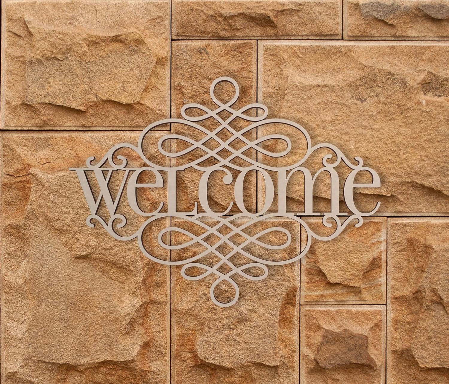 Decorative 'welcome' sign on a stone wall