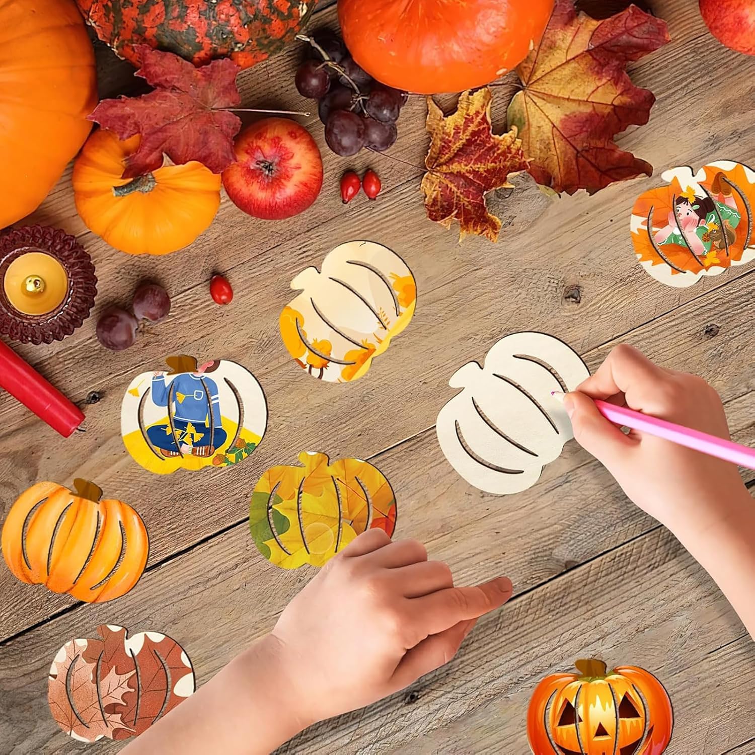 Children's hands coloring pumpkin-shaped stickers on a wooden table with pumpkins and leaves.
