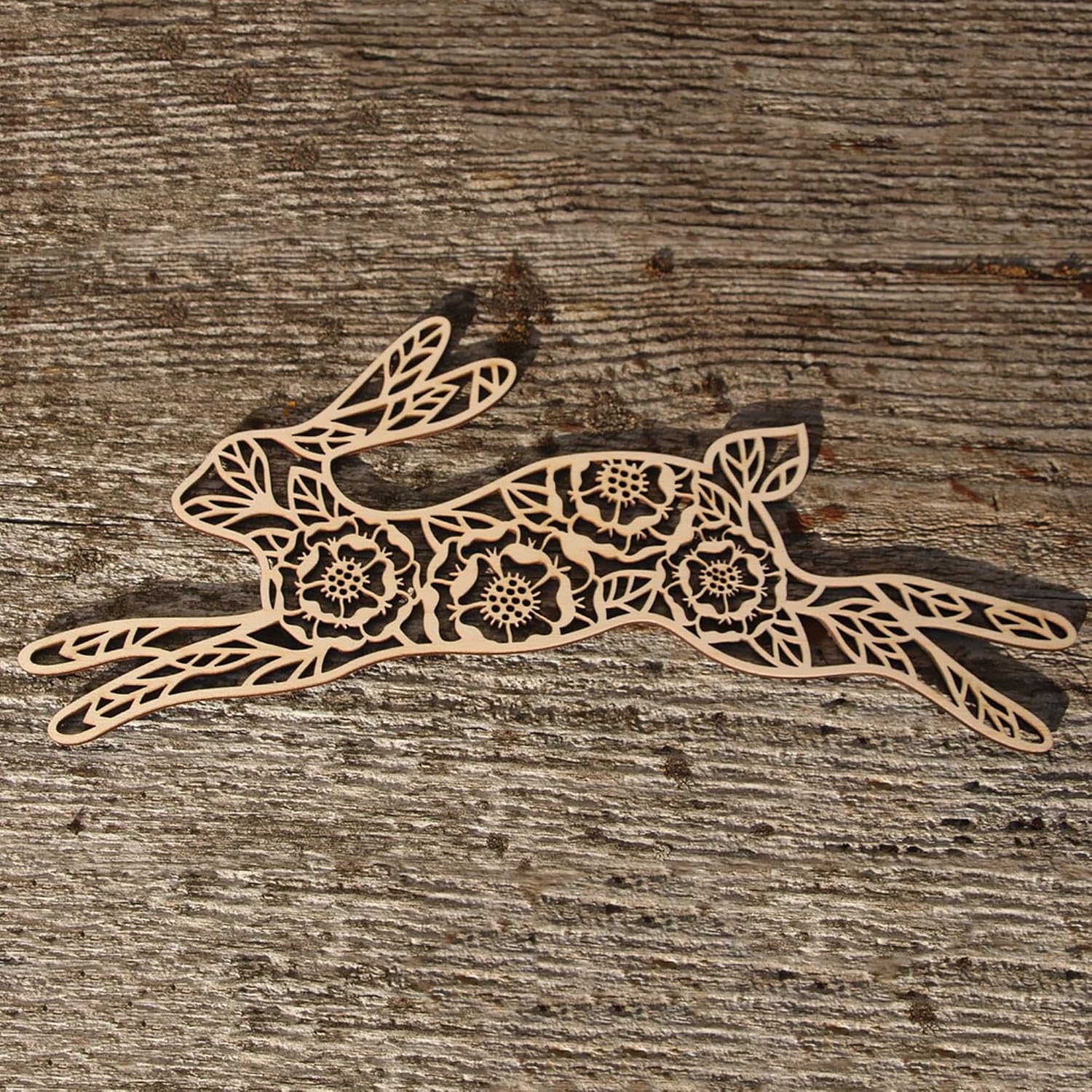 Decorative wooden hare with floral patterns on a wooden surface