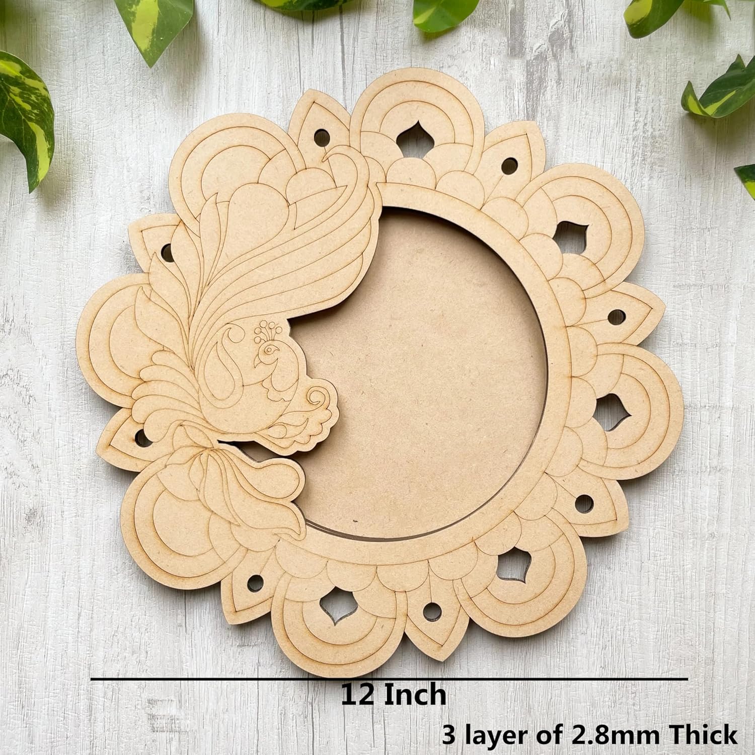 Decorative wooden frame with intricate cut-out design on a light wooden surface.