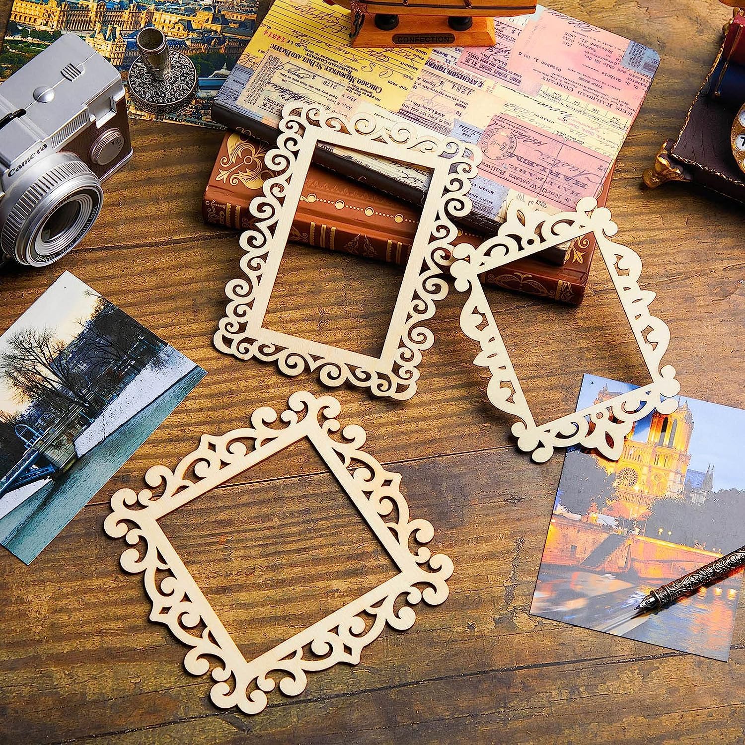 Decorative wooden frames on a wooden surface with vintage books and photos.