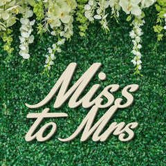 Decorative sign with 'Miss to Mrs' text on a green floral background