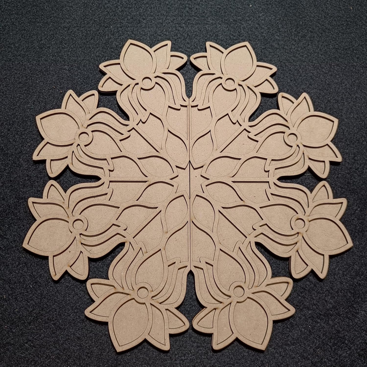Decorative wooden snowflake cutout on a black background