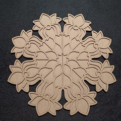 Decorative wooden snowflake cutout on a black background