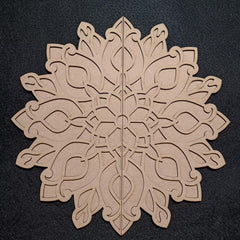 Decorative wooden snowflake cutout on a black background