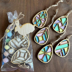 Decorative wooden ornaments with geometric patterns on a wooden surface