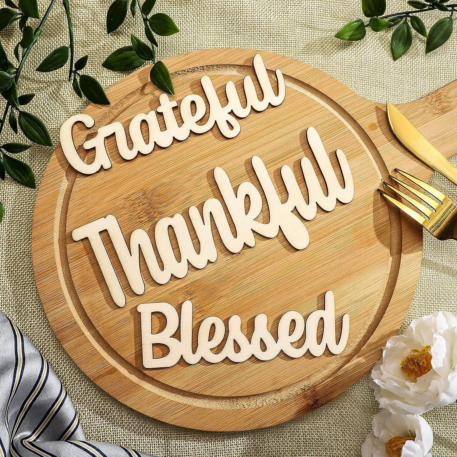 Wooden cutting board with 'Grateful Thankful Blessed' text on a decorative background