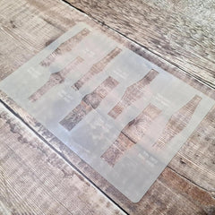 Transparent stencil with geometric shapes on a wooden surface