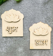 Two wooden lotus-shaped nameplates with engraved text on a gray surface.