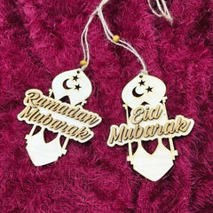Decorative hanging tags with 'Ramadan Mubarak' and 'Eid Mubarak' text on a textured pink background.