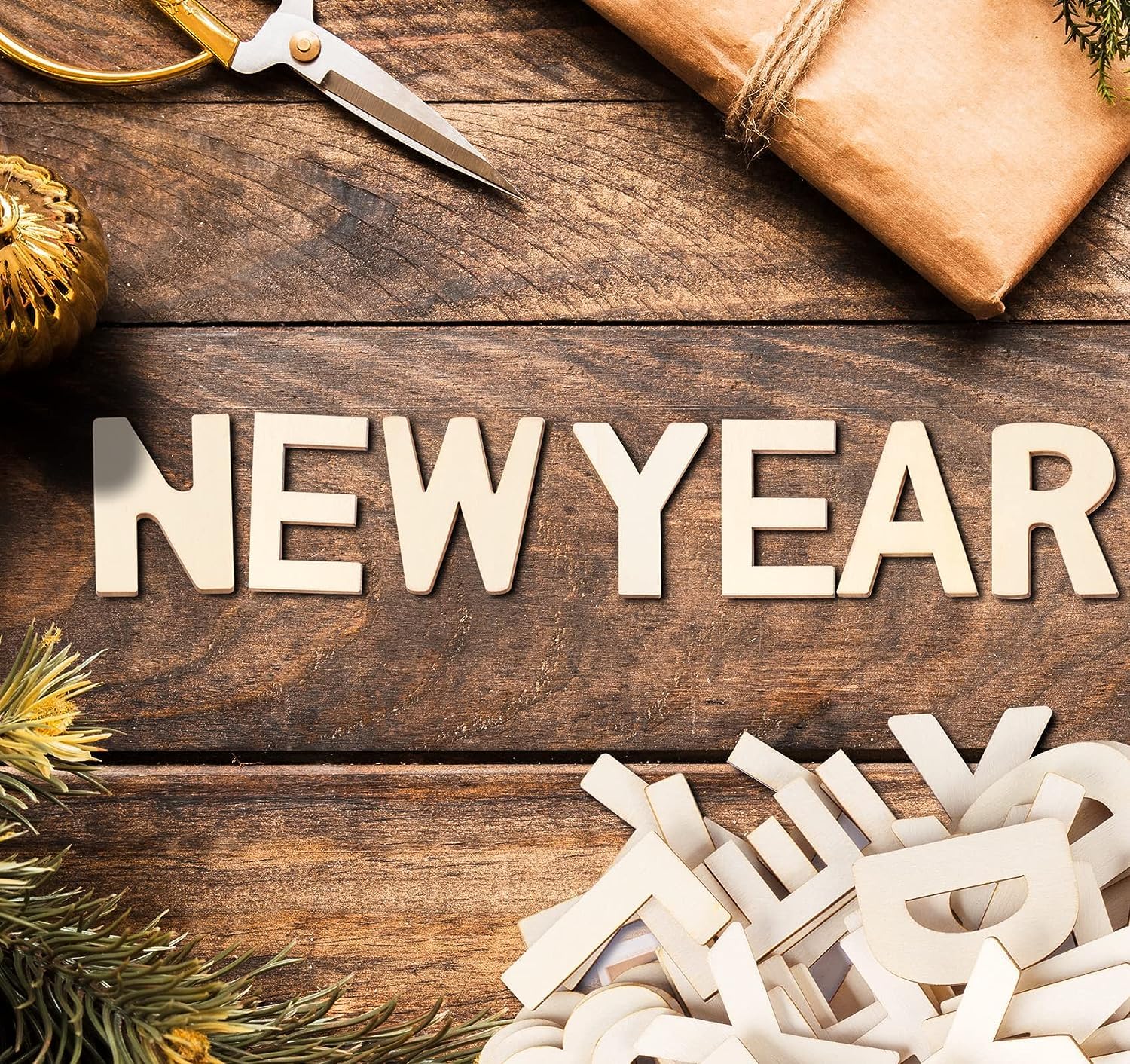 Wooden letters spelling 'NEW YEAR' on a rustic wooden surface with decorative items.
