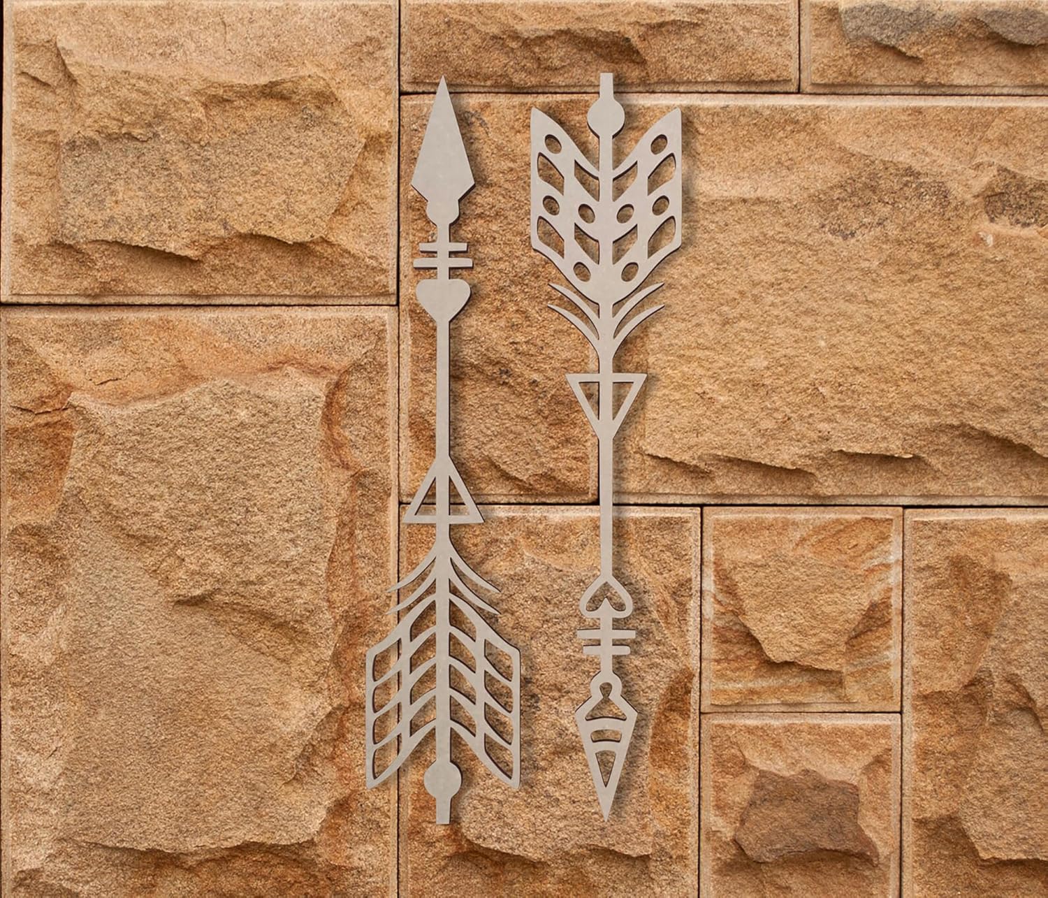 Decorative metal arrow designs on a stone wall