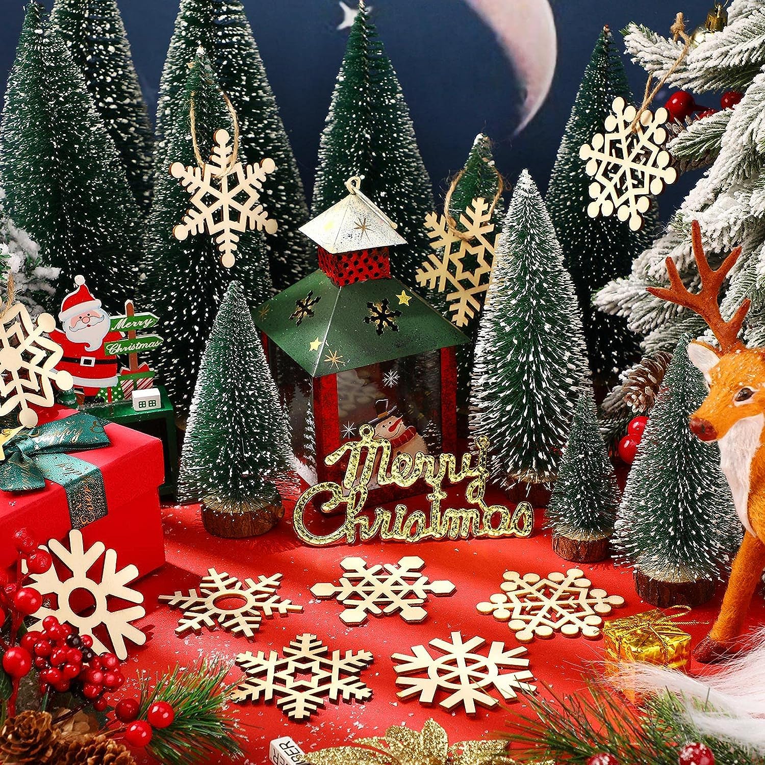 Christmas-themed display with trees, ornaments, and 'Merry Christmas' sign on a red base.