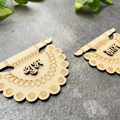 Two wooden decorative items with intricate patterns on a gray surface.