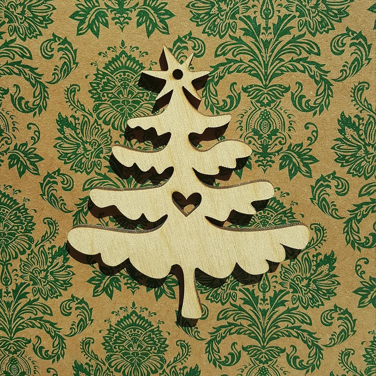 Wooden Christmas tree decoration on a patterned paper background