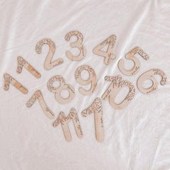 Wooden numbers on a textured white background