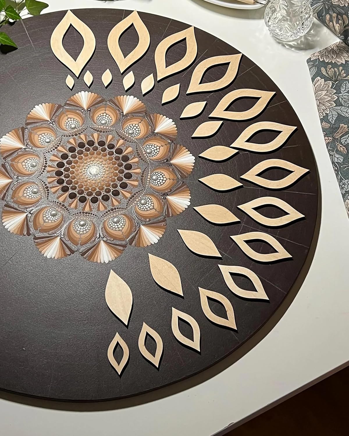 Decorative round mat with geometric patterns on a white surface