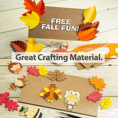 Crafting materials with fall-themed cutouts and leaves on a wooden surface.