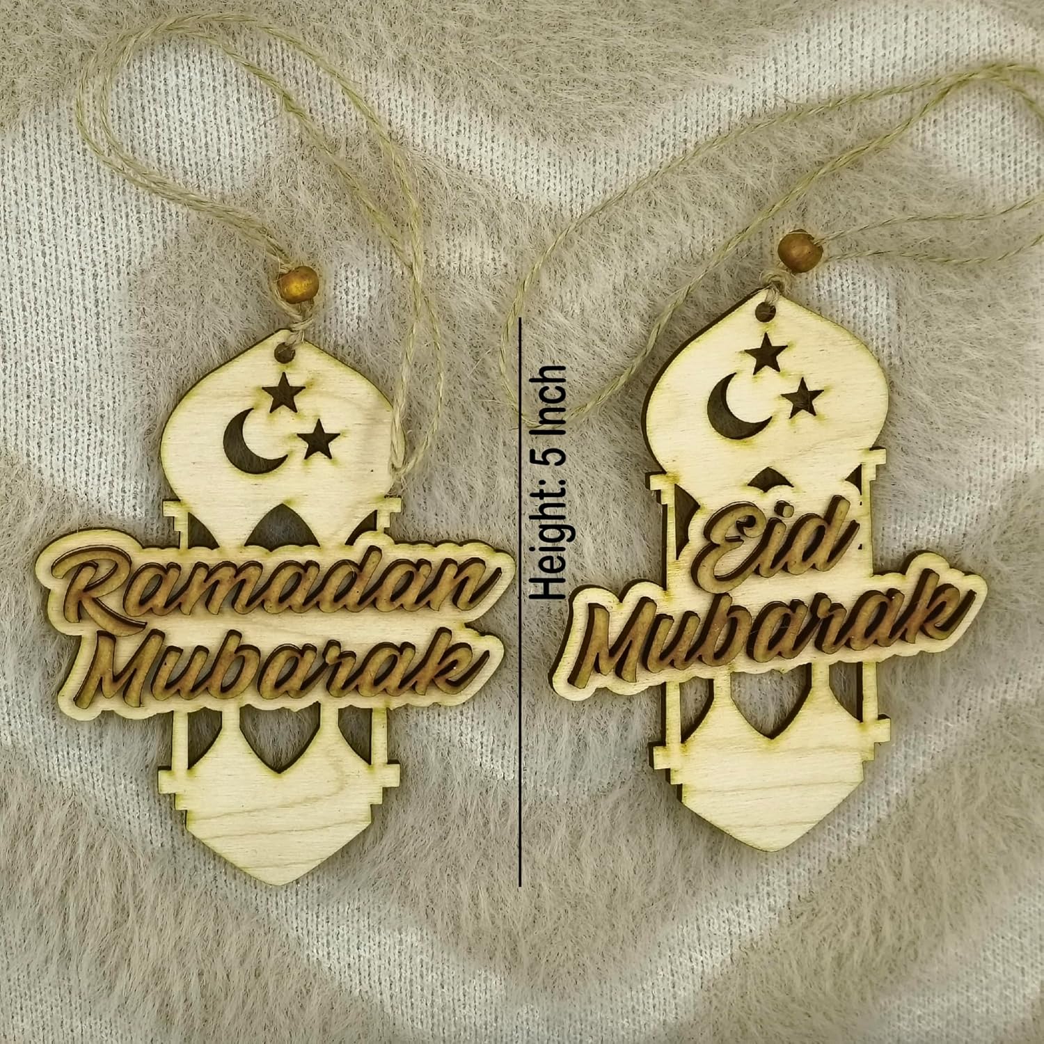Two wooden decorations with 'Ramadan Mubarak' and 'Eid Mubarak' text on a textured background.