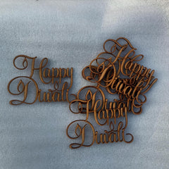Wooden decorative pieces with 'Happy Diwali' text on a light blue background