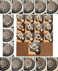 Collection of metallic stencils with various patterns on a white background