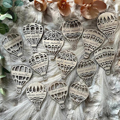 Wooden hot air balloon-shaped milestones with milestone text on a fur background