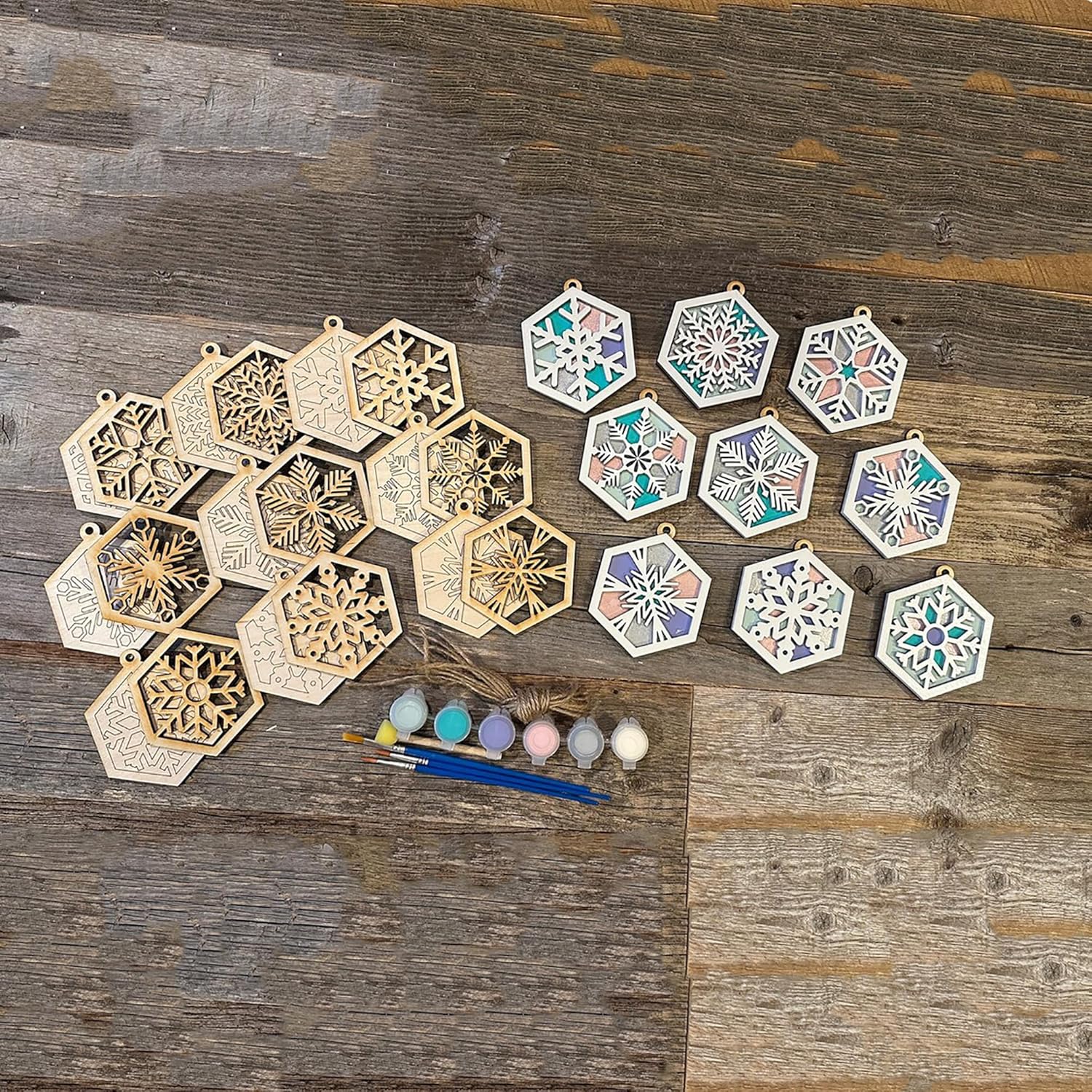 Decorative hexagonal stencils with paint and brushes on a wooden surface