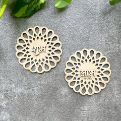 Decorative wooden pieces with intricate patterns on a gray surface.