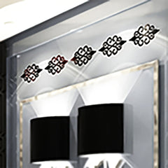 Decorative wall stickers on a mirror with a lamp in the background
