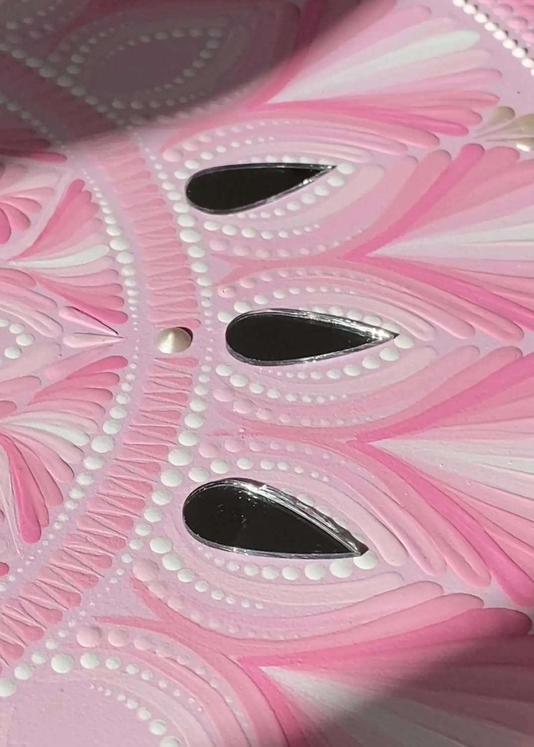 Close-up of a pink and white decorative item with black accents