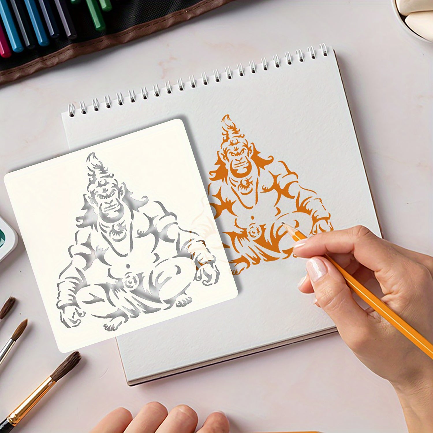 Artistic process of creating a color illustration on a sketchbook with markers and paint.