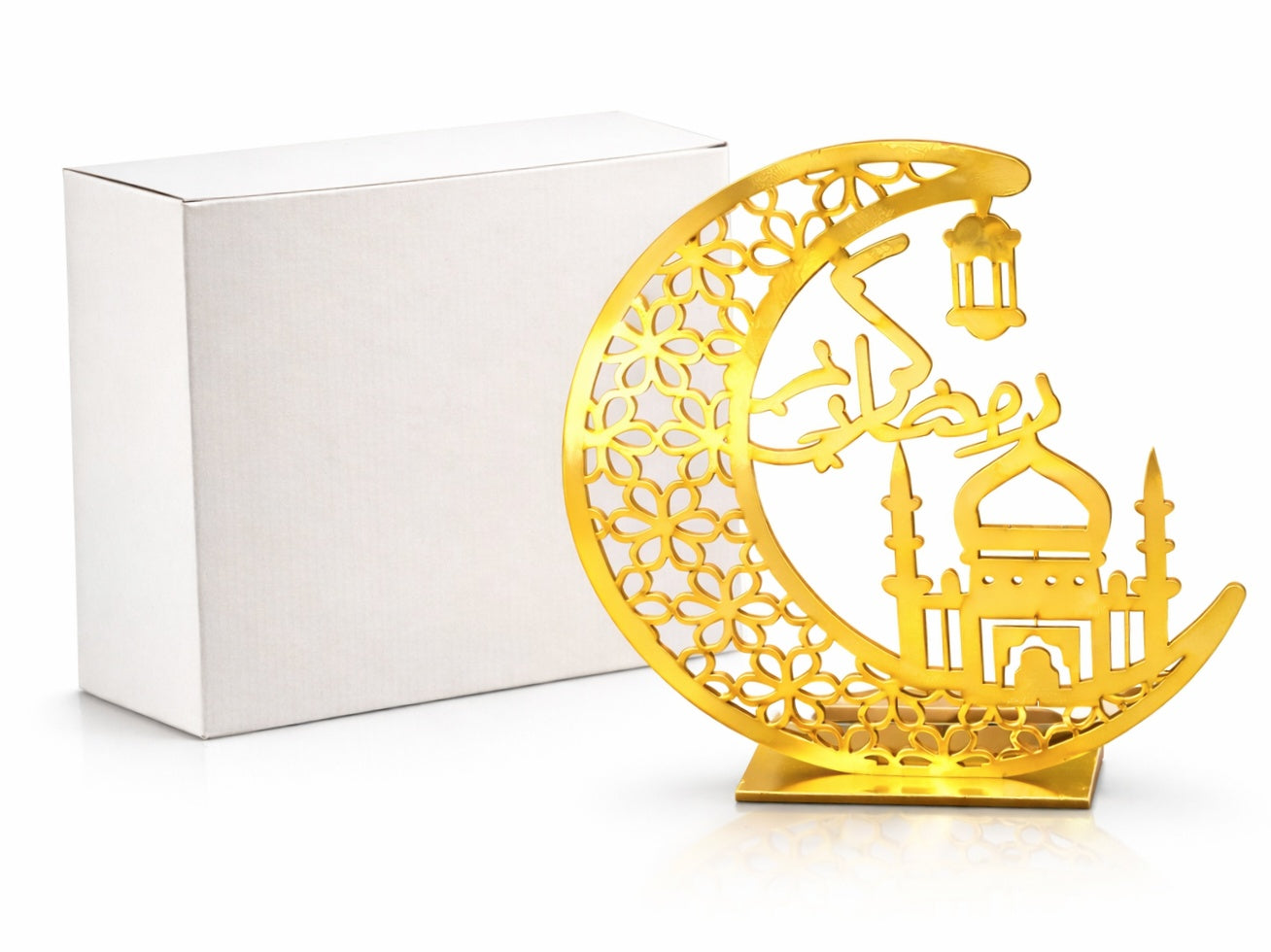 Decorative gold metal crescent moon with intricate designs on a white background