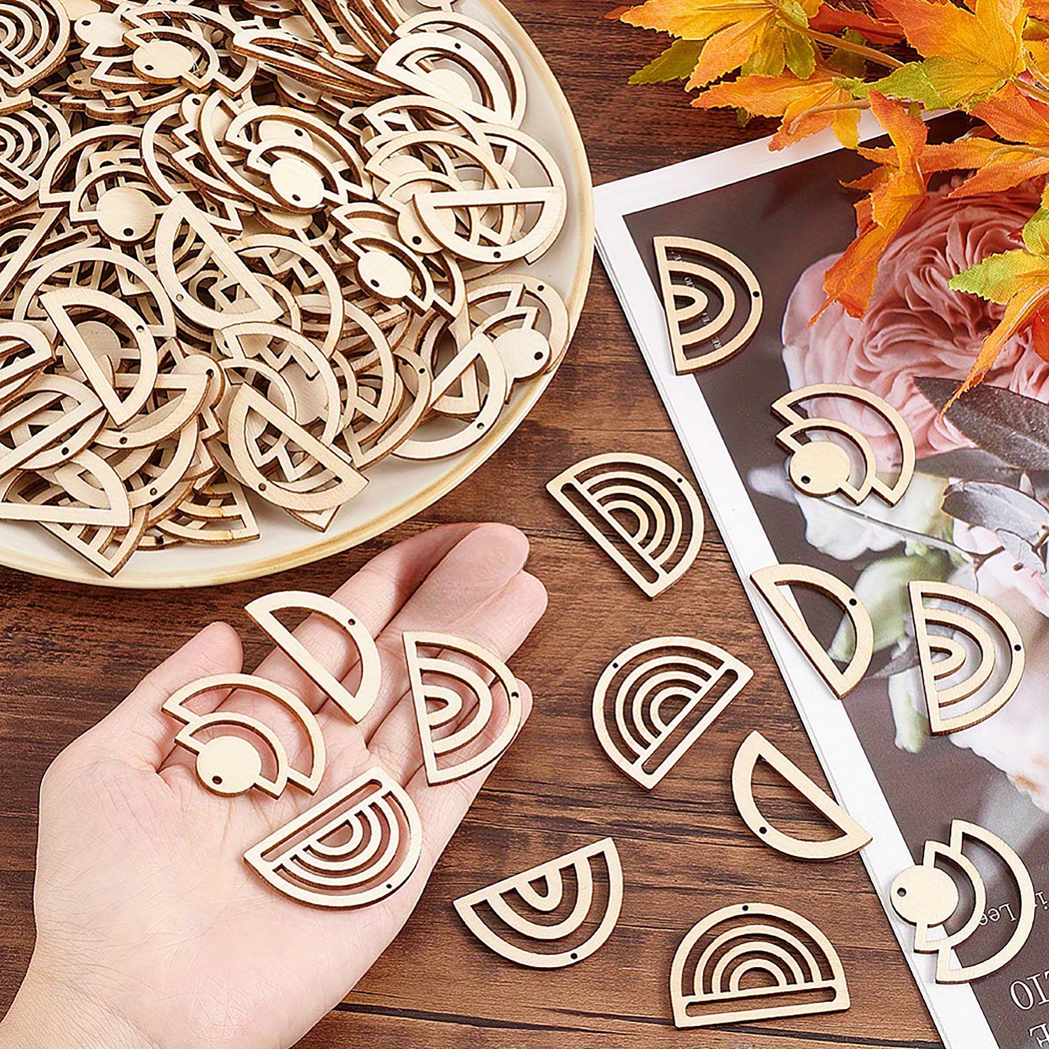 Wooden geometric shapes on a wooden surface with a hand holding a cutout shape.
