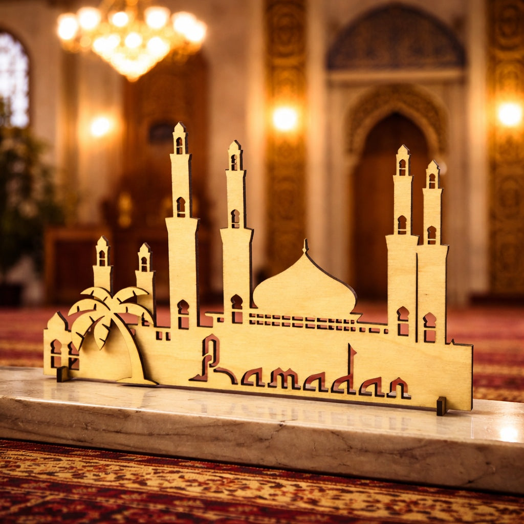 Decorative model of a mosque with 'Ramadan' on a marble surface in a mosque setting.